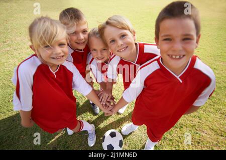 The field holds promise. Shot of a childrens soccer team. Stock Photo