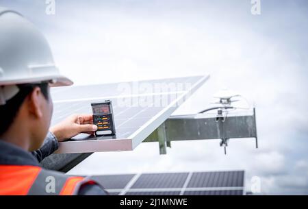 Technicians are checking the irradiance of the solar panel in the solar power plant so that the power generation can operate at full capacity. Alterna Stock Photo