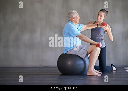 Helping patients stay strong and healthy. Shot of a a physical therapist working with a senior man. Stock Photo