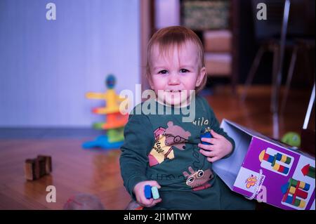Portrait of cute little boy playing on the floor Stock Photo