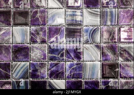 Abstract purple background. Small green modern mosaic tile in bathroom. glass ceramic texture. purple mosaic wall Stock Photo