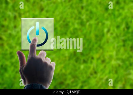 hand pushing a button ON green transition concept Stock Photo