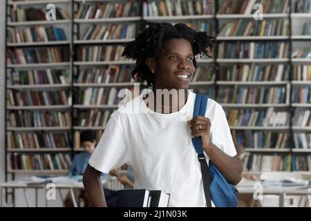 Happy African student guy posing in campus library Stock Photo