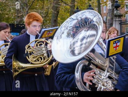 Close up of ginger haired boy playing French Horn and girl playing tuba with Christ’s Hospital School Band in the Lord Mayor’s Show 2021, London. Stock Photo