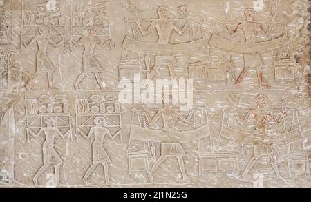 Cairo, Egyptian Museum, tomb of Harmin, a large relief : Second register, funeral procession,  female mourners and men bringing offerings. Stock Photo