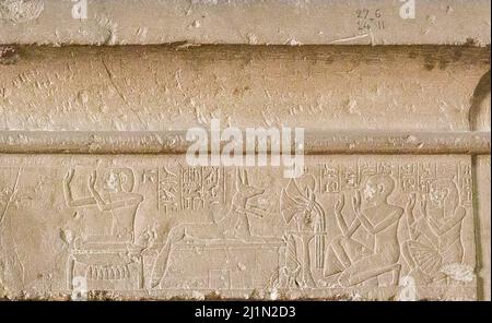 Cairo, Egyptian Museum, from Guiza, tomb of Khaemouaset. Lintel with cornice, deceased and his son Ptahnufer kneeling before  Isis and Anubis. Stock Photo