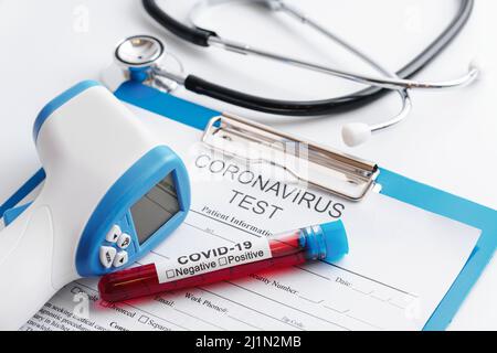 Blood samples, stethoscope and digital infrared thermometer Stock Photo