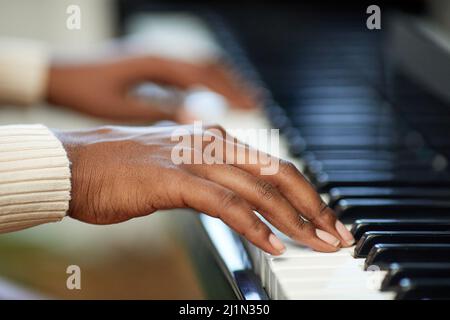 Close-up of female hands playing the piano during musical lesson Stock Photo