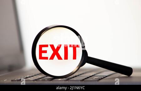 Word EXIT written with white paint on a glass door, modern security details Stock Photo