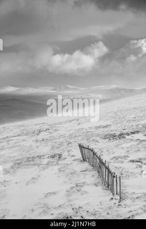 Black and white Winter landscape image from mountain top looking across to Rannoch Moor Stock Photo
