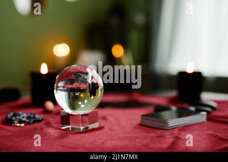 Background image of crystal ball and tarot cards on red velvet table in fortune tellers shop, copy space Stock Photo