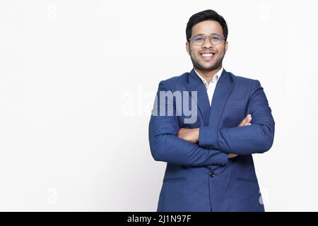 Young hispanic businessman with arms crossed smiling happy. Stock Photo