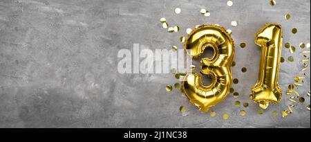 Yellow foil balloon number, number thirty one on a concrete background. Birthday card with inscription 31. Anniversary concept. for anniversary Stock Photo