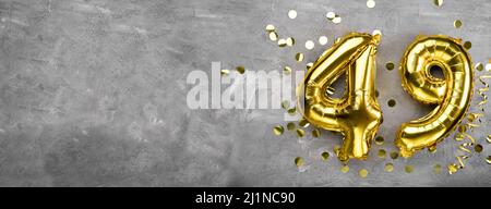 Yellow foil balloon number, number forty nine concrete background. Greeting card with the inscription 49. Anniversary concept. for anniversary Stock Photo