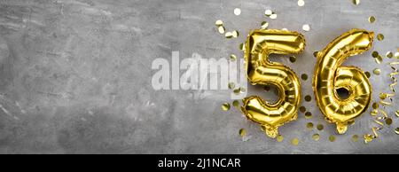 Yellow foil balloon number, number fifty six concrete background. Greeting card with the inscription 56. Anniversary concept. for anniversary Stock Photo