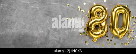Yellow foil balloon number, number eighty on a concrete background. Greeting card with the inscription 80. Anniversary concept. for anniversary Stock Photo