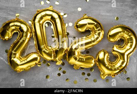 Happy New Year 2023. Background of golden balloons. Decorative design elements. Celebrate the party. Poster, banner, greeting card. Stock Photo