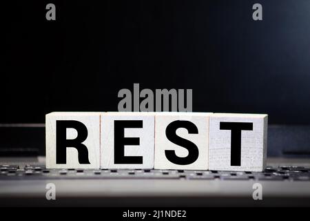 Rest word from wooden blocks on desk Stock Photo