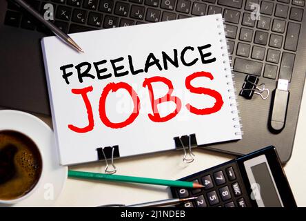 Word writing text FREELANCE JOBS. Business concept for situation in which an employee works mainly from home Note paper taped to black computer screen Stock Photo