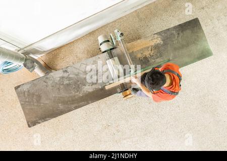 Faceless man working at woodworking planer in workshop Stock Photo