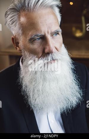 Handsome bearded senior man posing in studio Stock Photo