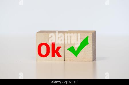 Word OK made with building blocks on white background with reflection. Stock Photo