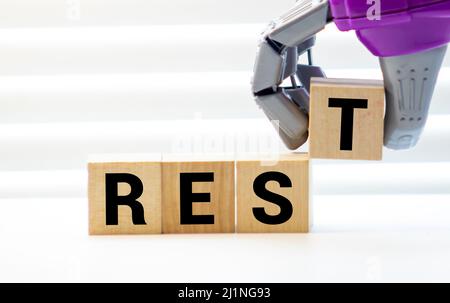 Rest word from wooden blocks on desk. Stock Photo