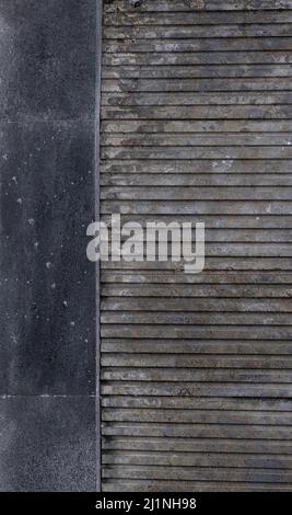 Gray 3 dimensional concrete shutter panel against deep blue old cement wall, urban background or wallpaper. Copy space. Stock Photo