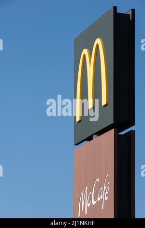 McDonald's restaurant sign or advertising column with McCafe and McDrive in Lemmer, the Netherlands. World's largest chain of fast food restaurants Stock Photo