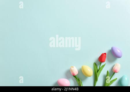 Easter banner with tulips and eggs. Copy space. Flat lay, top view. Stock Photo