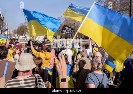 London UK, 26th March 2022. Thousands of people join a Stand with Ukraine march  and vigil in central London in protest against the Russian invasion. The march passes along Piccadilly on the way to Trafalgar Square. Stock Photo