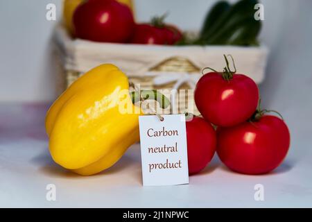 Carbon neutral product label on tomatoes and yellow bell pepper. Carbon labeling. Net zero carbon, emissions free. Organic farm products from local ma Stock Photo