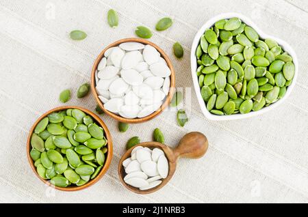 The Pumpkin seeds green and unpeeled in wooden bowl Stock Photo - Alamy