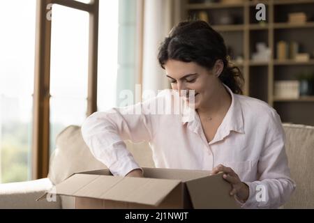 Happy satisfied customer unpacking carton box with purchase Stock Photo