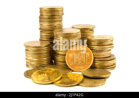 Golden coins isolated on white background. Ukrainian coins with the coat of arms of Ukraine, trident is symbol of the state Stock Photo