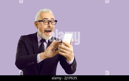 Senior man looking at sum of cashback on mobile phone with funny happy surprised expression Stock Photo