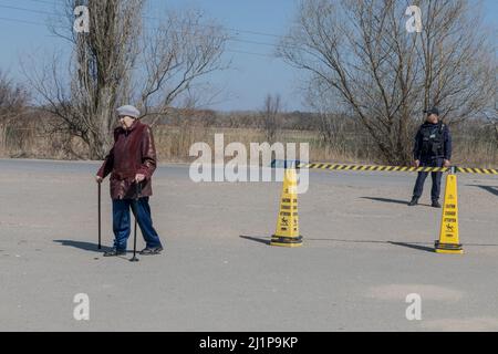 An elderly woman with walking difficulties is seen crossing the border to reach Moldavian territory. After the Russian government announced that in a new strategy it would concentrate its troops in the Donbass region, the eastern part of Ukraine, Ukrainians from the south of the country, especially from the Odessa region, began to re-enter their country with the hope that the conflict will no longer reach their homes as some seek to escape and reach safer places. Stock Photo
