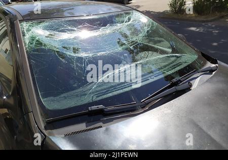 Broken glass of the broken windshield after a heavy car accident ruined the windscreen and caused an injury that shattered and cracked the glass Stock Photo
