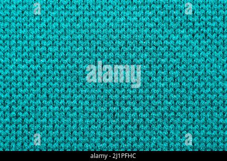 Blue synthetic knitted fabric close up. Knitted fabric texture background Stock Photo