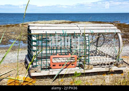 Lobster trap on the edge of St-Lawrence river, Quebec, Canada Stock Photo