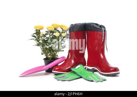 Garden tools with flower pot and boots isolated on white background Stock Photo