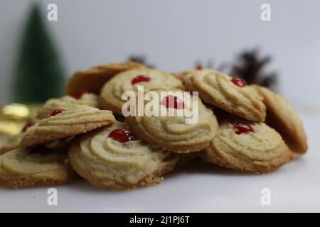 Vanilla Butter cookies. Vanilla flavored Cookies made of flour, butter and sugar. Shot with festive decorations around on white background. Stock Photo