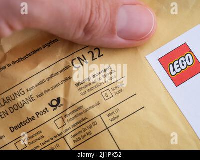 Tambov, Russian Federation - August 23, 2021 A woman fingers holding envelope sent via Deutsche Post from Lego Stock Photo