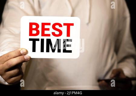 Best TIME written in a notebook near a white alarm clock Stock Photo