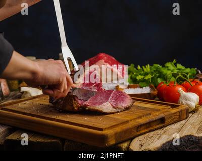 Pieces of raw lamb fat dumba are fried in a black cauldron, cooking food  Stock Photo - Alamy