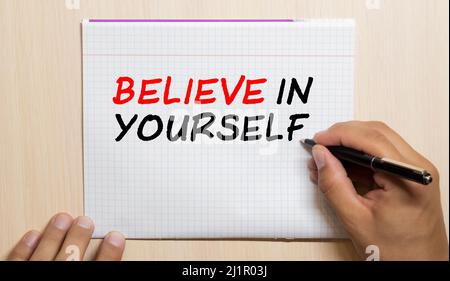 Believe in yourself. word written on a sticky note on the gray fridge. Stock Photo