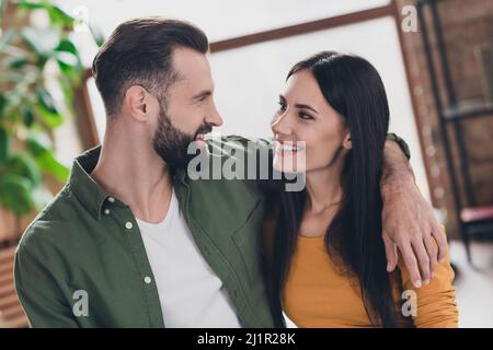 Portrait of attractive sweet cheerful couple hugging spending spare time staying safe at home house flat indoors Stock Photo