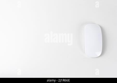 White wireless mouse on white backgroung, copy space Stock Photo