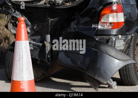 Pylone cone in front of car crash collision accident scene Stock Photo