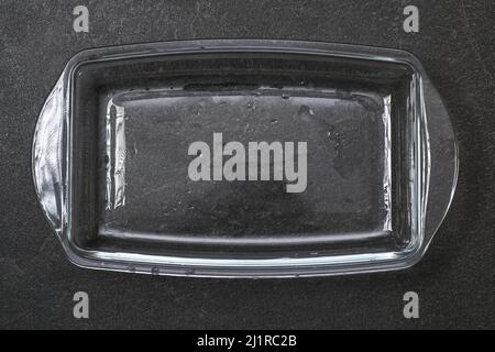 A baking dish cleaned from a thick layer of carbon. Glassware for baking after washing with a steam cleaner. Stock Photo